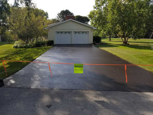 Driveway which has been seal coated and does NOT have mistakes